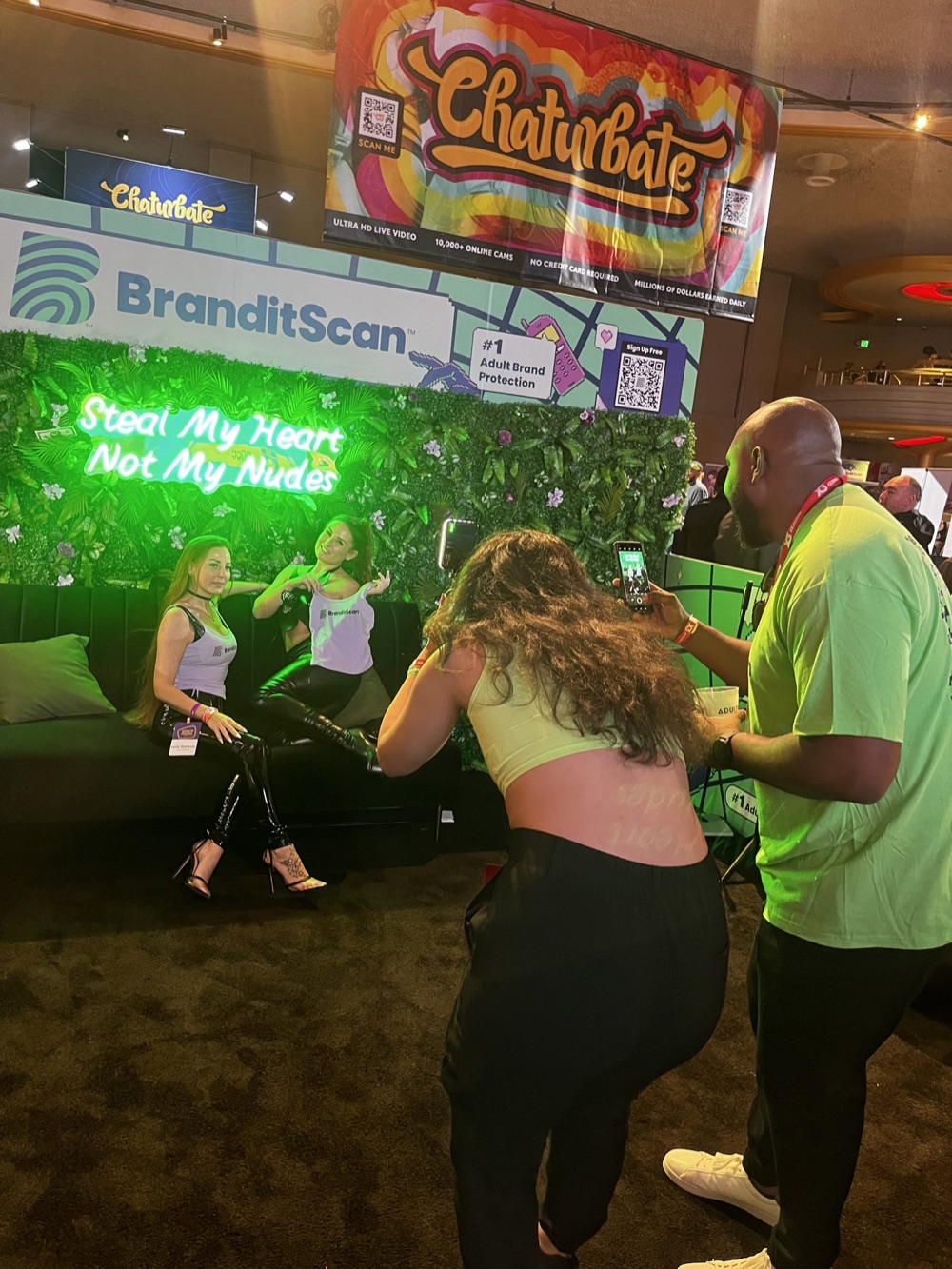 The BranditScan lounge in 2024 with the neon sign: Steal My Heart Not My Nudes